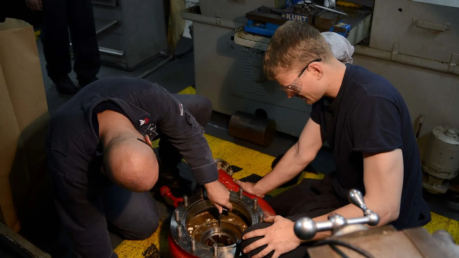 Two technicians assembling a seal and impeller set on the shop floor