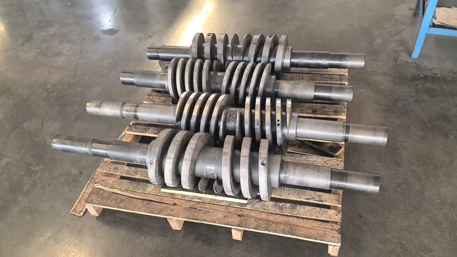 Machined shaft sleeves laid out on a pallet for size verification