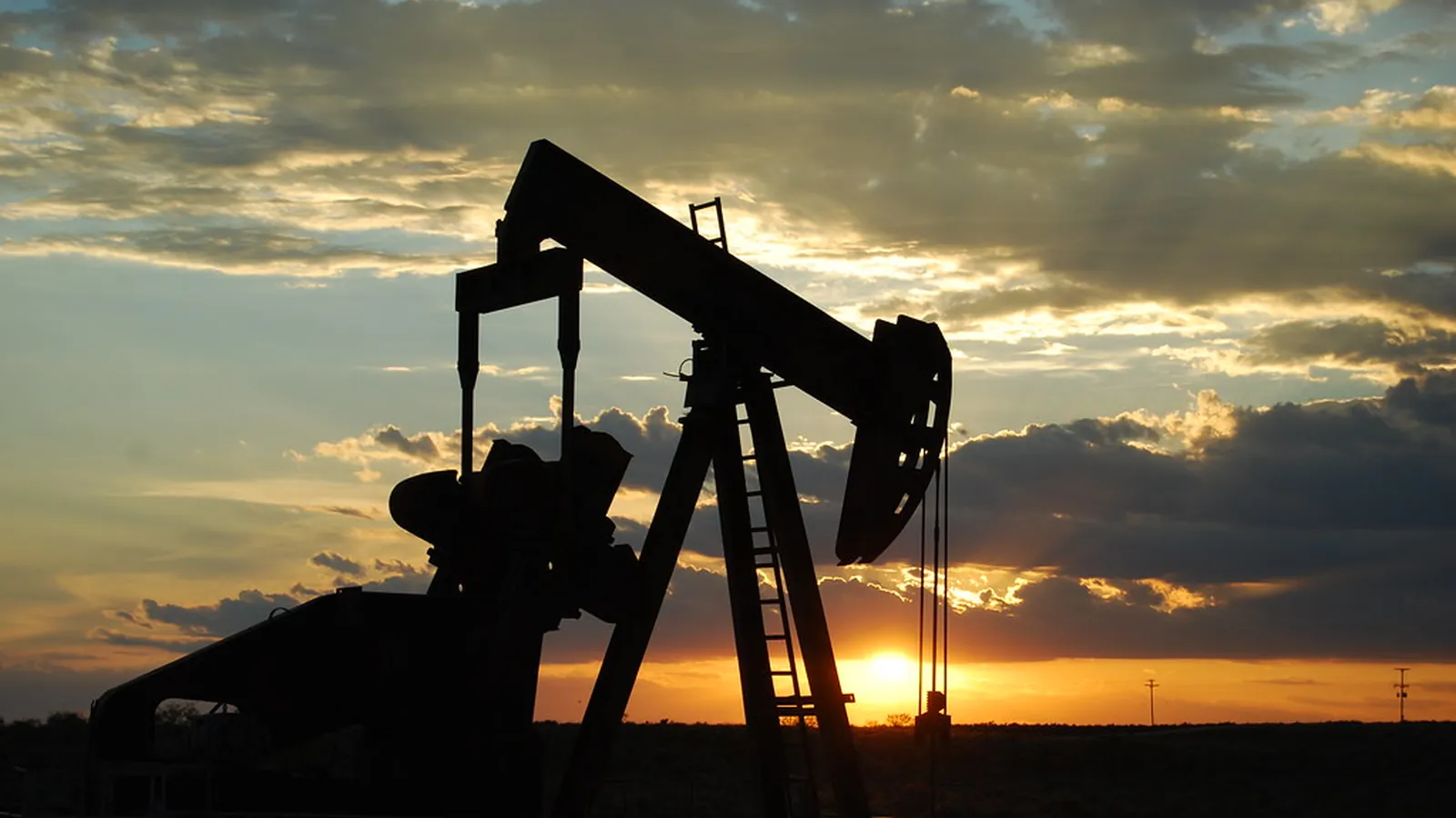 Beam pumping units at sunset — pumping cost in the field