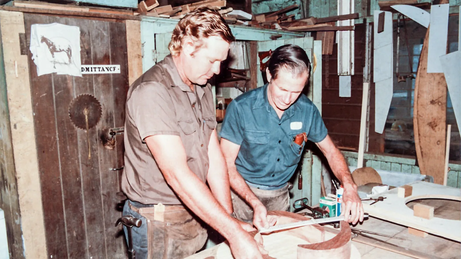 Two workers assembling an impeller and seal at a bench