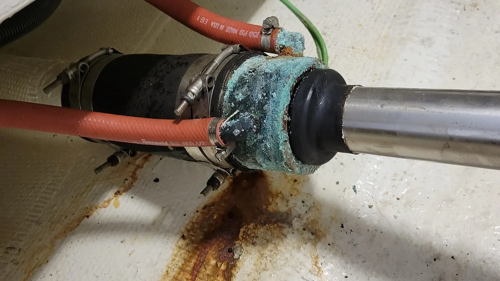 Failed elastomer bellows covered in mineral deposits