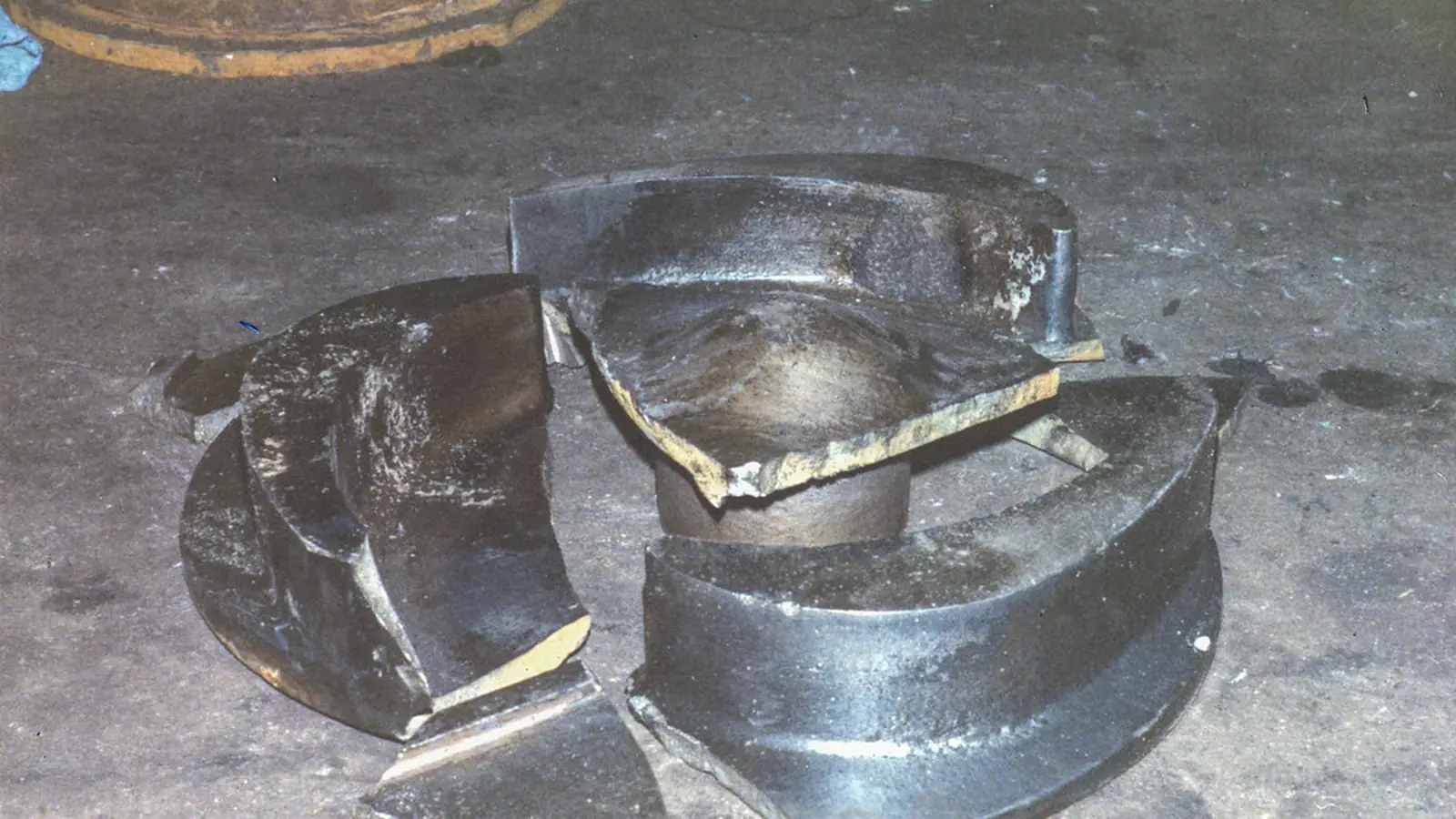 Worn impeller and seal face parts resting on concrete